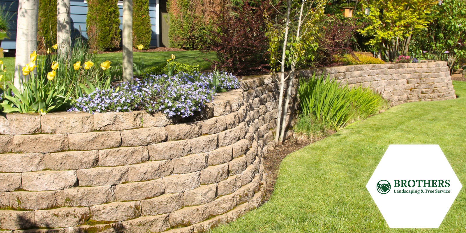 Retaining wall providing structural support on a slope