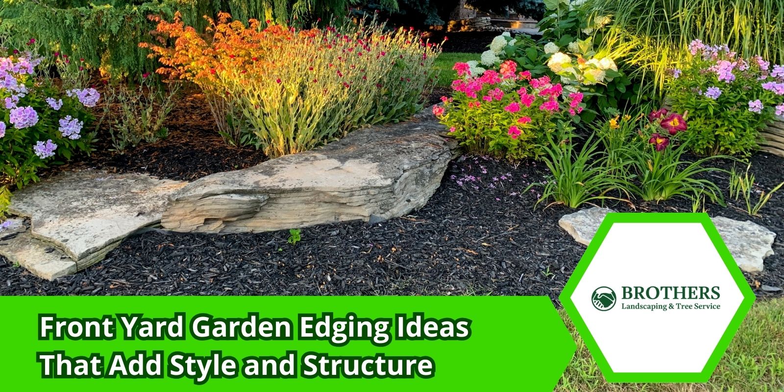 Flower bed with clean natural stone edging in front yard